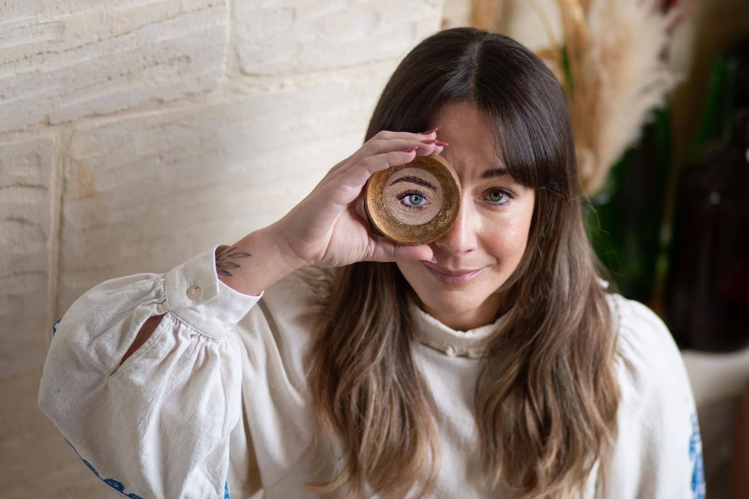 Sarah Muscat Azzopardi holding an embroidery hoop, The Secret Rose