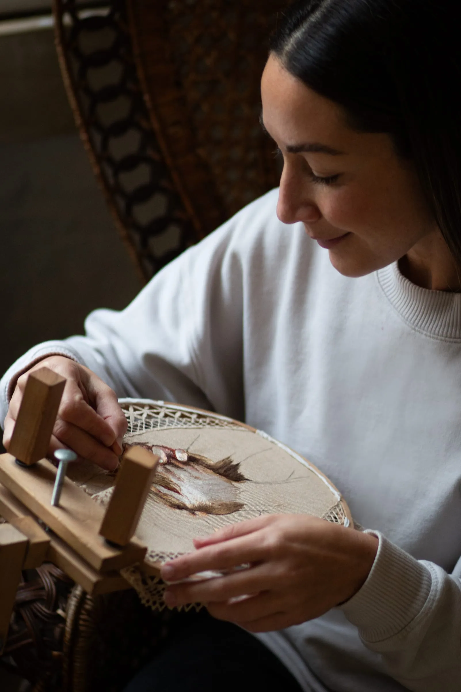 Sarah Muscat Azzopardi hand-stitching a piece in her Gozo studio